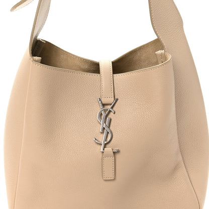 Light beige hobo bag with YSL logo hardware at center and leather key fob