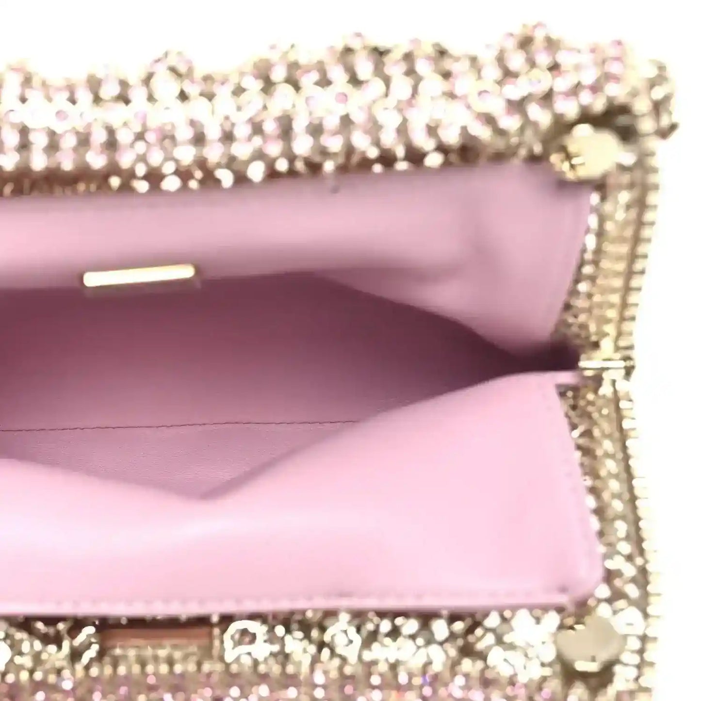 Chanel Mini 22 handbag interior view with pink leather lining under crystal flap.