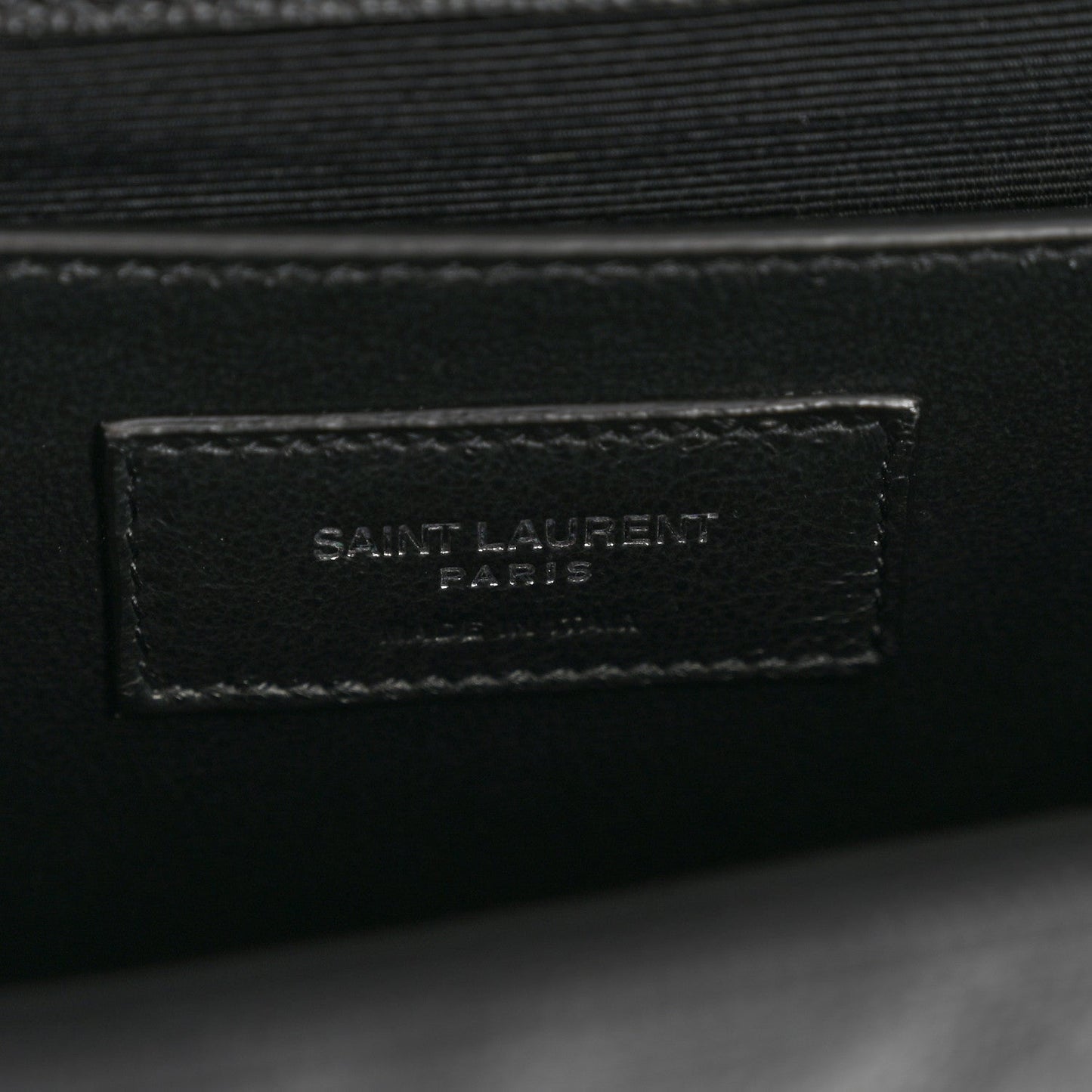 Black leather satchel interior with Saint Laurent Paris stamped patch