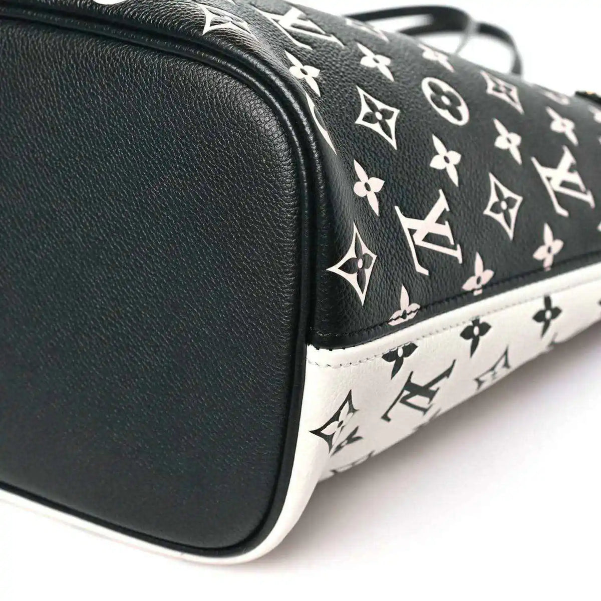 Neverfull MM pouch corner with black leather trim and black-and-white monogram canvas