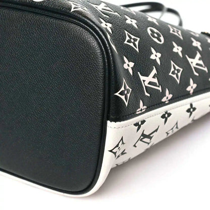 Neverfull MM pouch corner with black leather trim and black-and-white monogram canvas