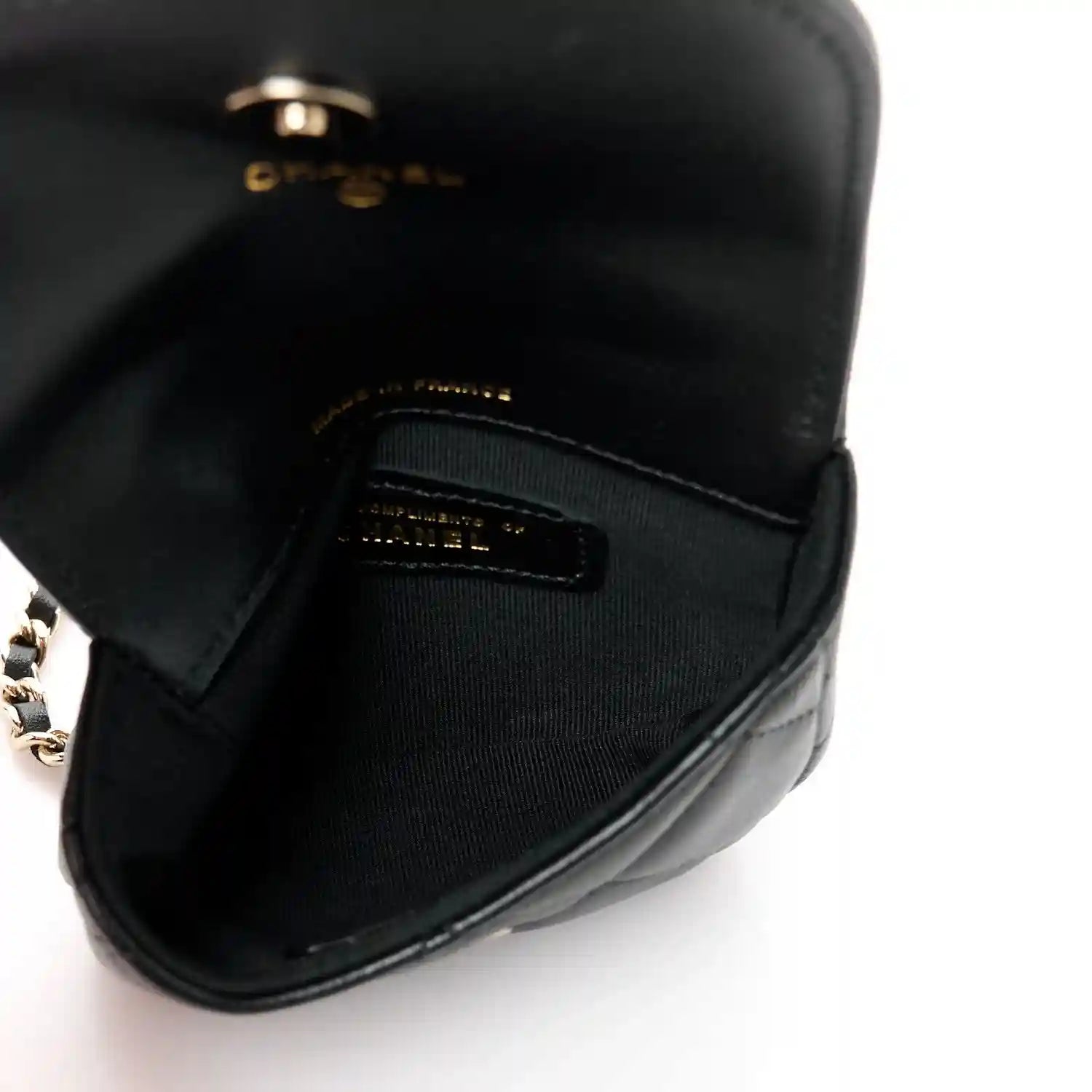 Black leather clutch back panel with gold-tone logo plate