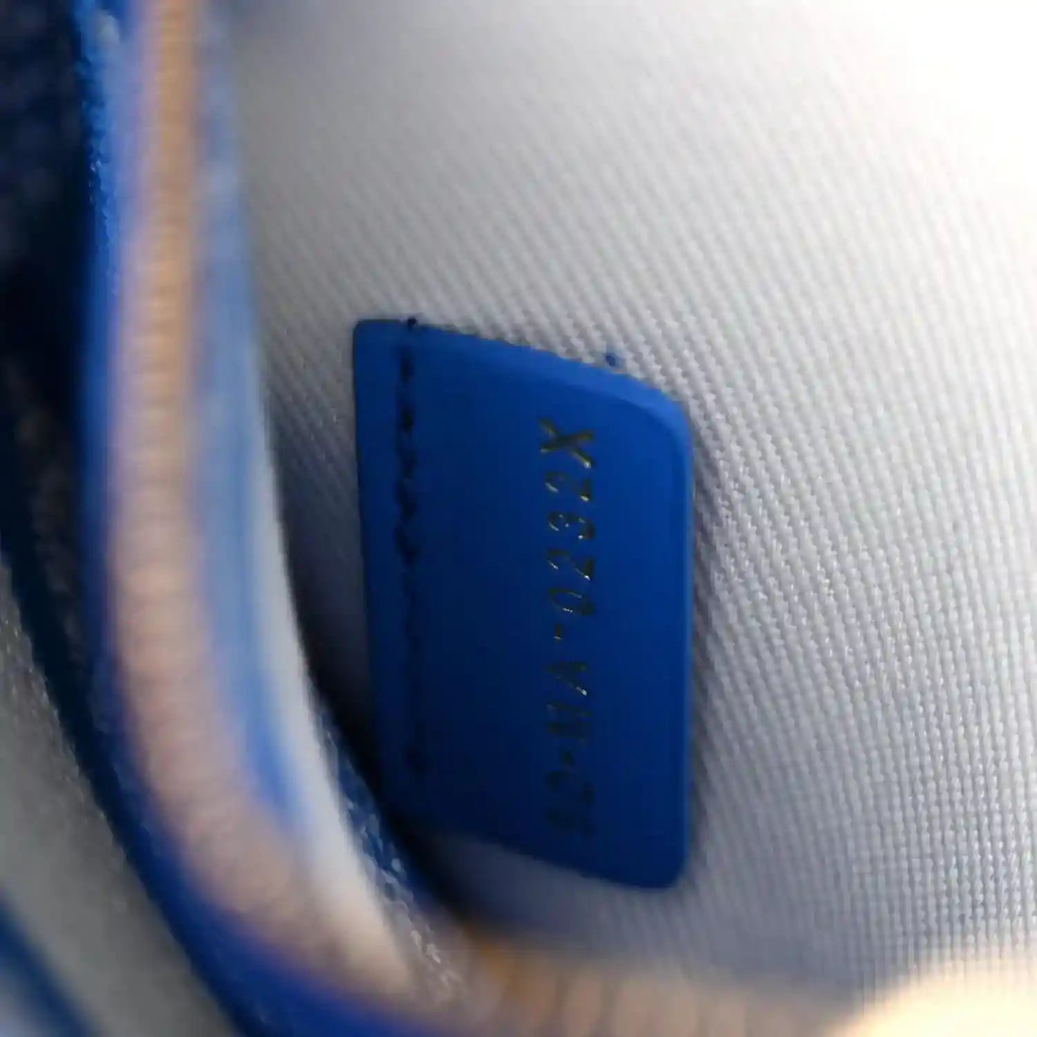 Blue interior panel with small gold logo stitching on Christian Dior handbag