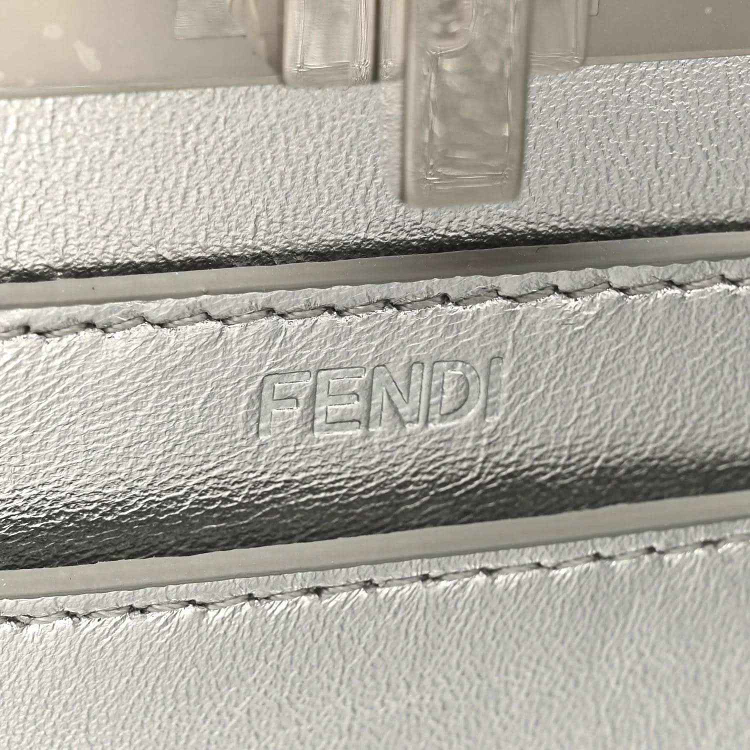 FENDI embossed on light gray leather lining near satchel flap