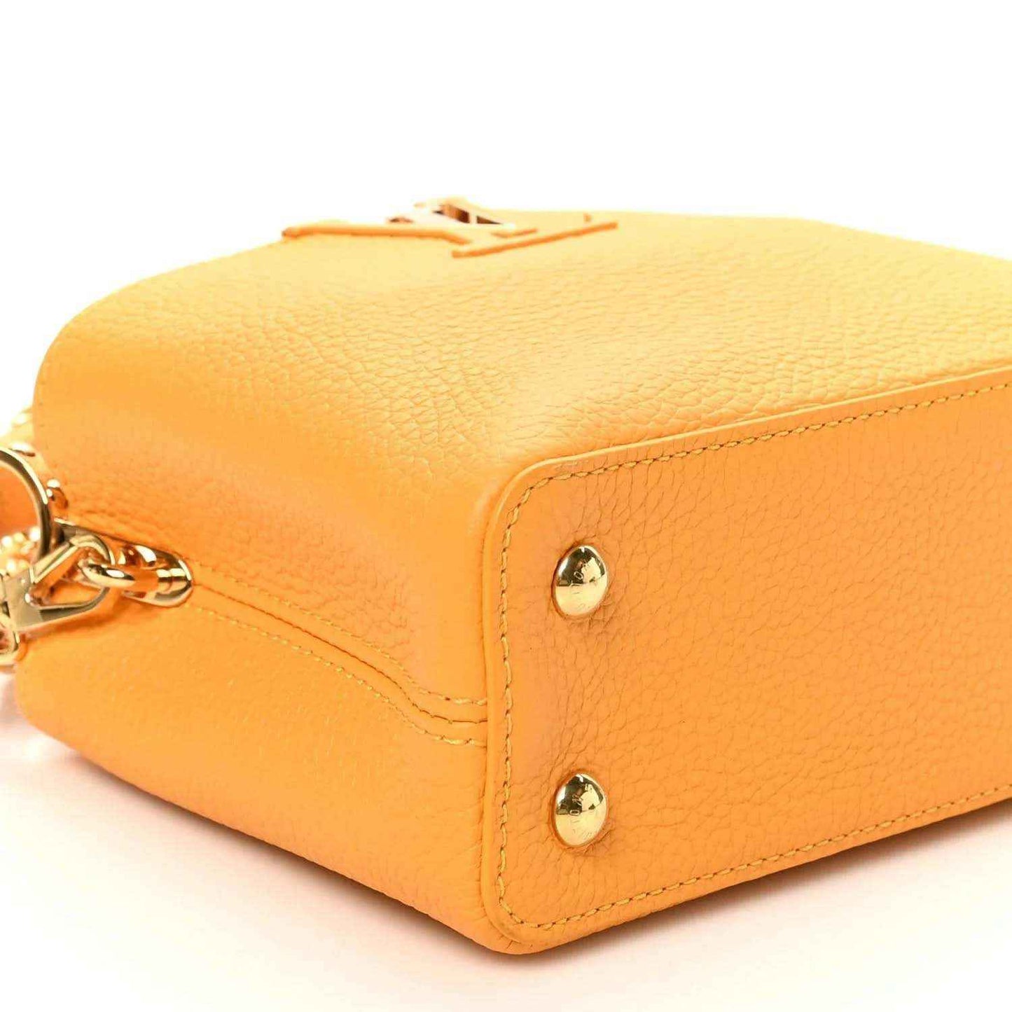 Mini Capucines handbag in yellow textured leather with gold-tone corner studs and clasp