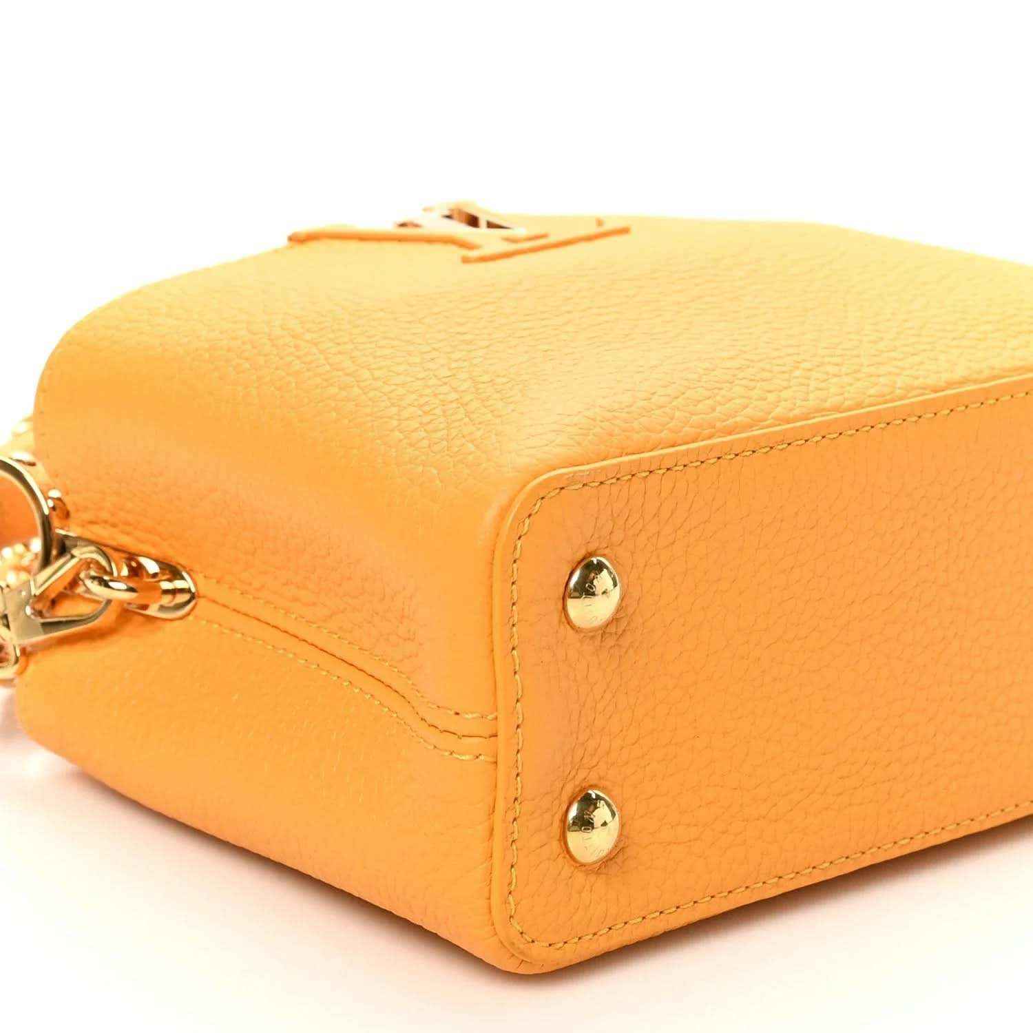 Mini Capucines handbag in yellow textured leather with gold-tone corner studs and clasp