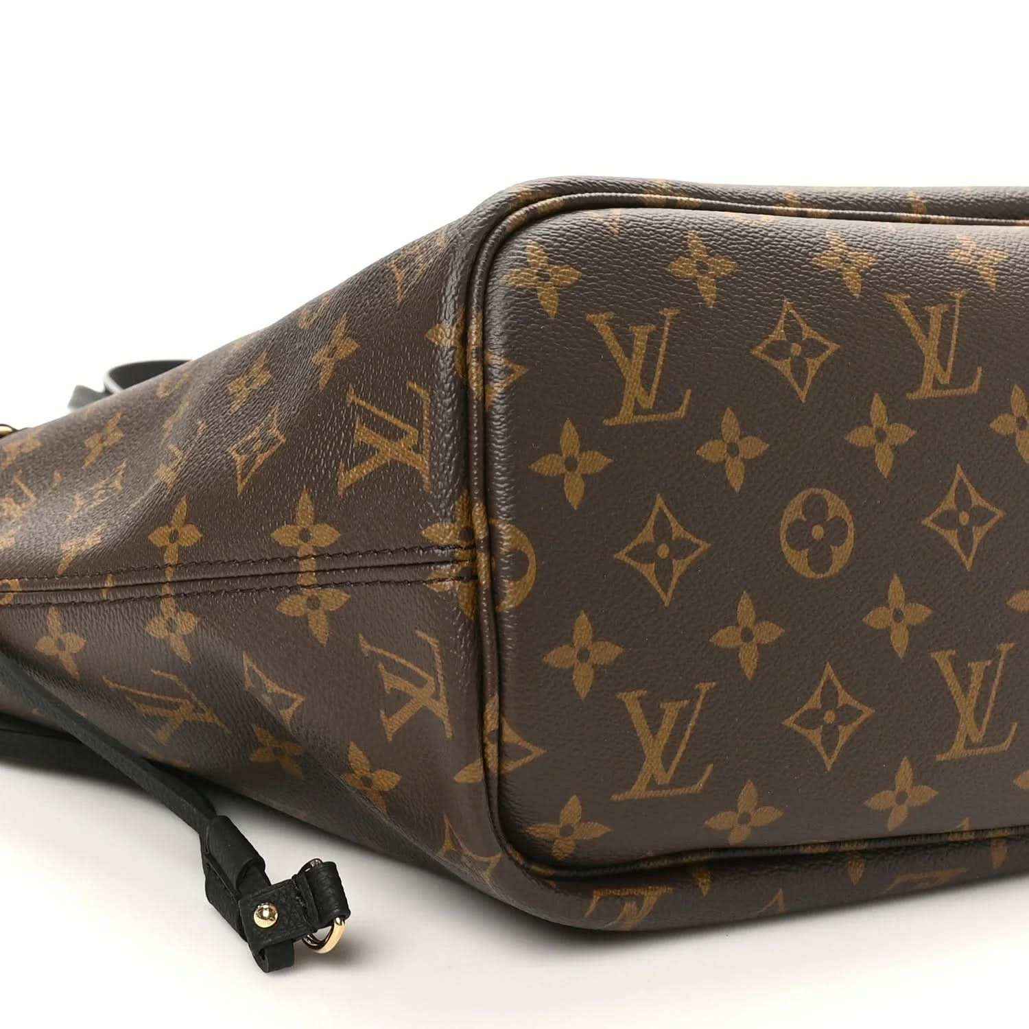 Monogram canvas tote with zip opening, brown leather trim, and strap hardware