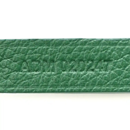 Green coated canvas label with embossed text