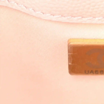 Light pink quilted leather mini handbag corner with gold-toned logo tab detail