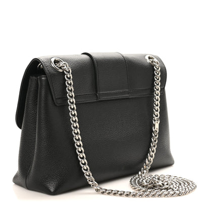 Black structured shoulder bag with chain strap and front flap clasp