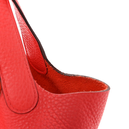 Rose leather tote bag side view with handle loops and interior lining