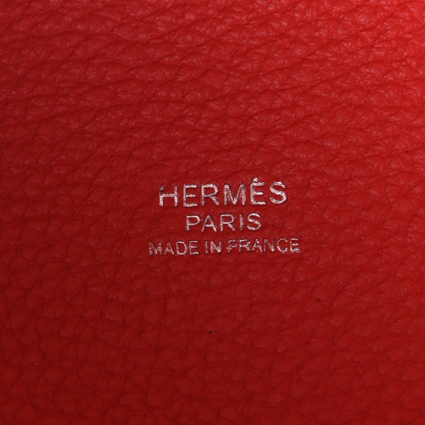 Red leather with embossed 'HERMES PARIS' text and 'MADE IN FRANCE'