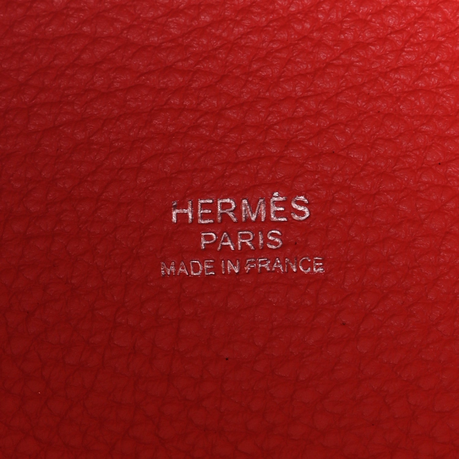 Red leather with embossed 'HERMES PARIS' text and 'MADE IN FRANCE'