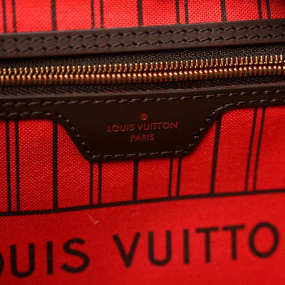 Red-lined interior with Louis Vuitton Paris logo on zip pocket