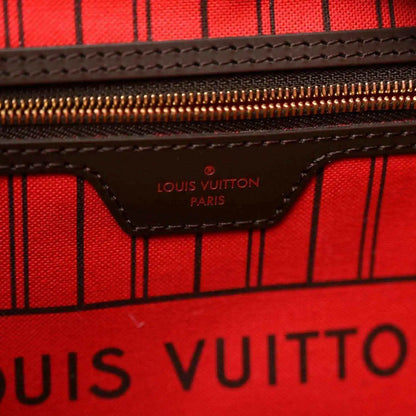 Red-lined interior with Louis Vuitton Paris logo on zip pocket