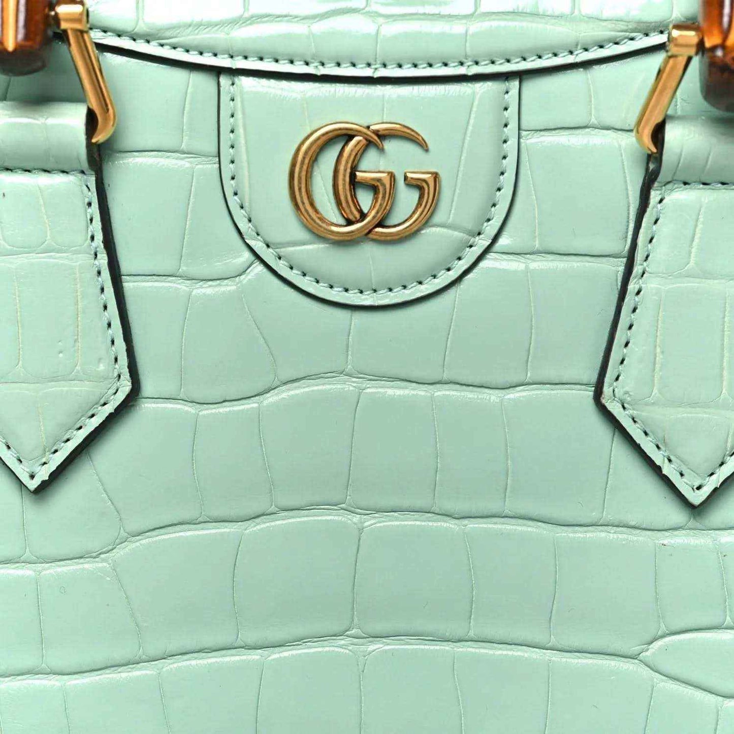 Green alligator-pattern tote bag front with gold-tone GG logo medallion