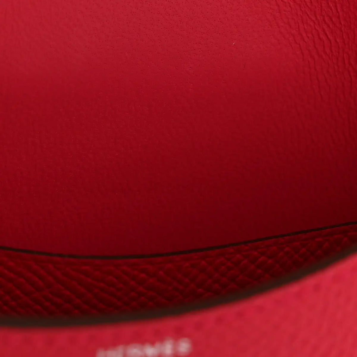Hermes slim wallet rose red leather closeup with seam and edge stitching