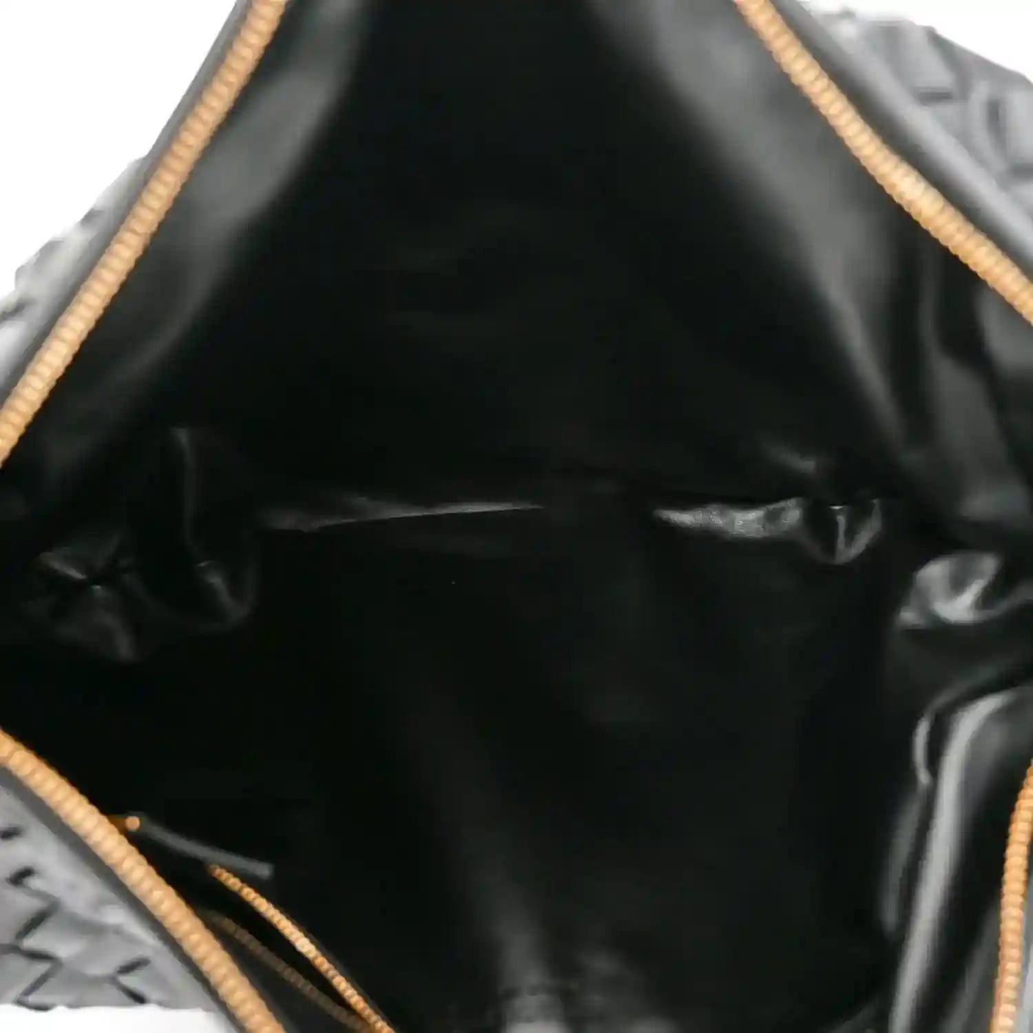 Black leather bag interior with gold-tone drawstring cord and lining