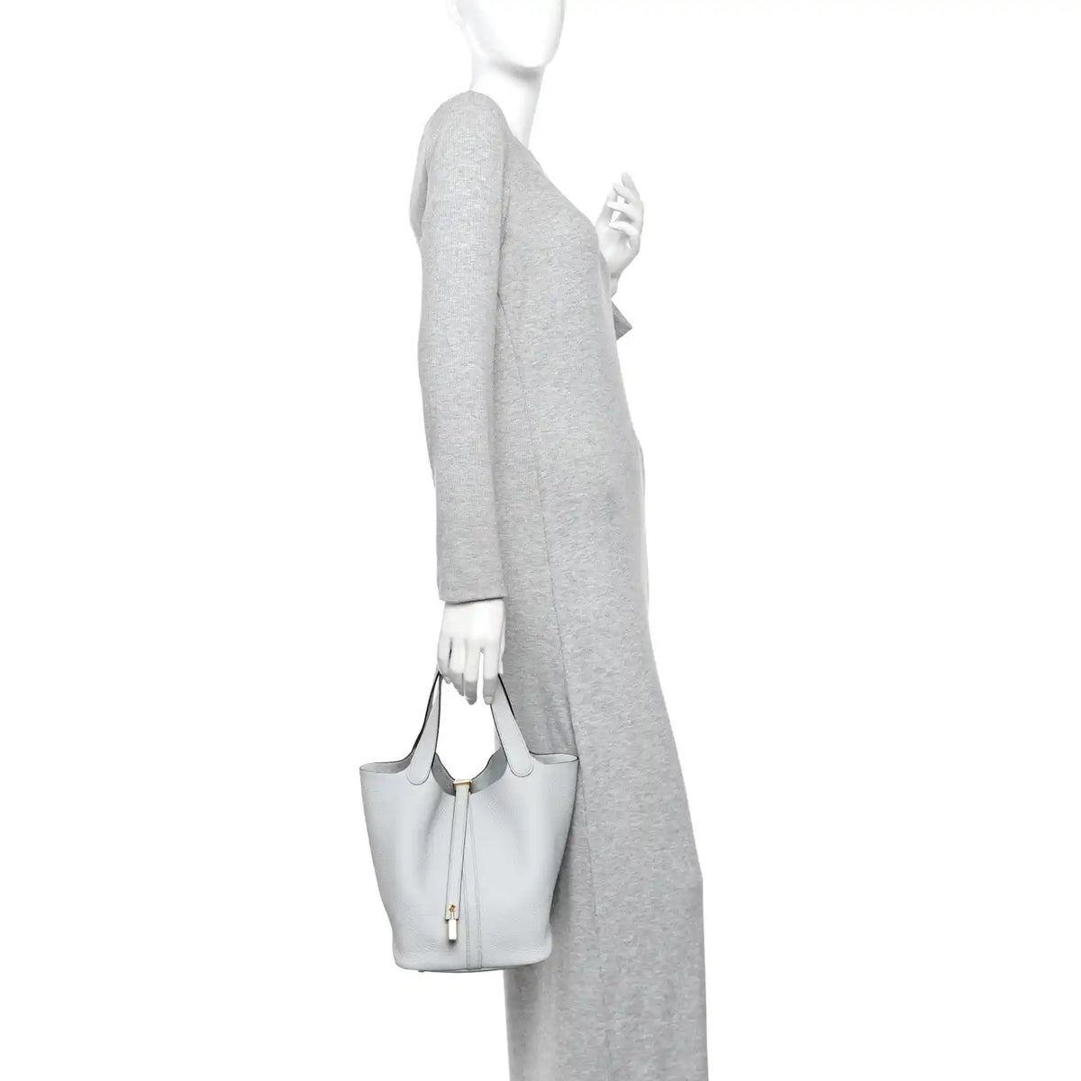 Light blue pebbled leather bucket tote with short handles and lock front