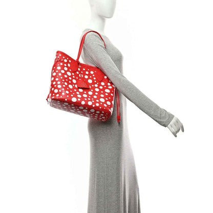 Red polka-dot tote bag on mannequin with shoulder strap and side fringe tie