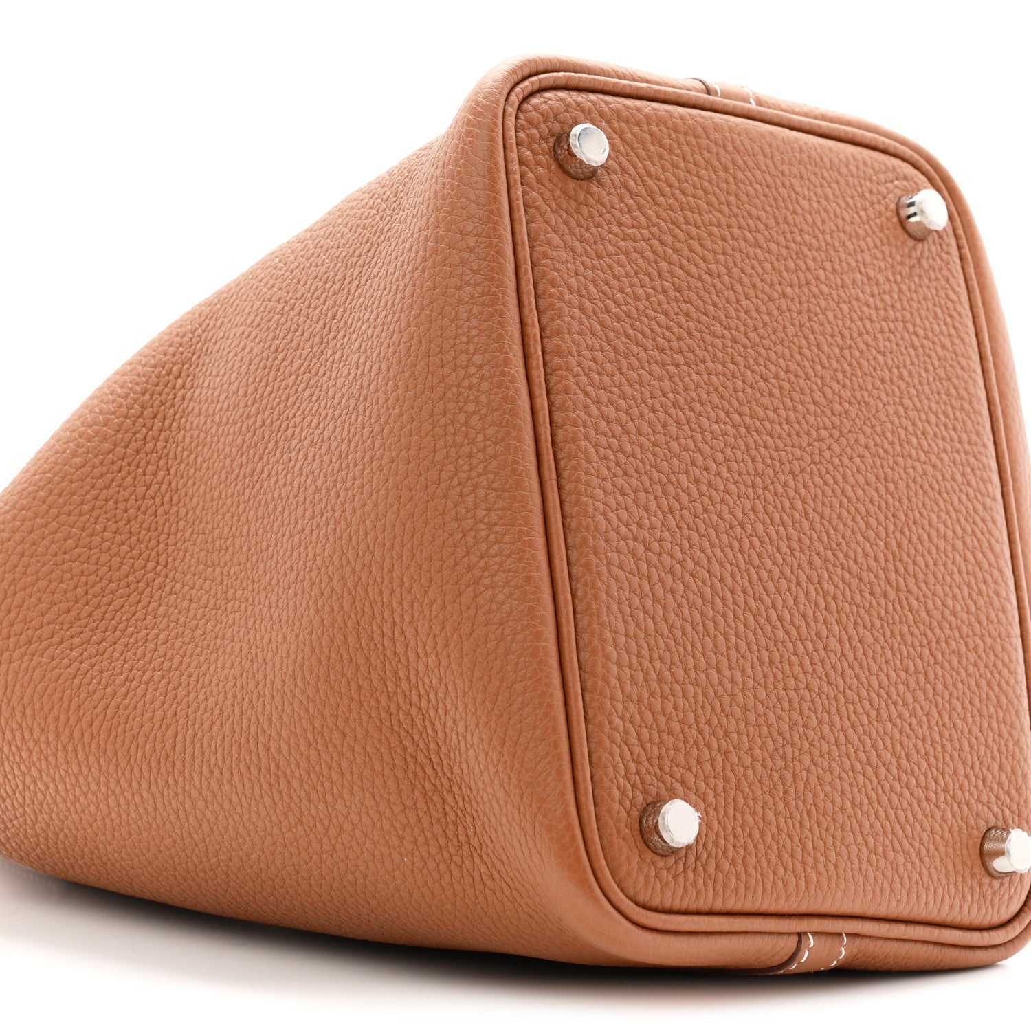 Brown leather bucket tote bag corner with snap buttons and structured shape