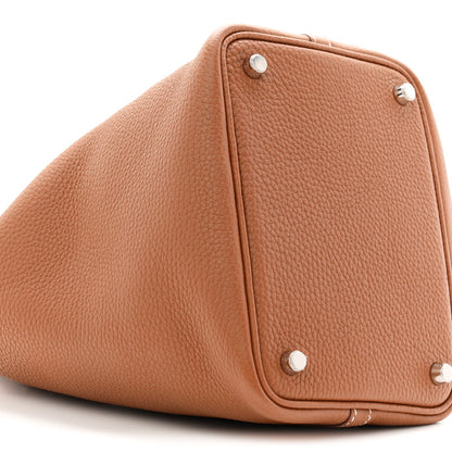 Brown leather bucket tote bag corner with snap buttons and structured shape