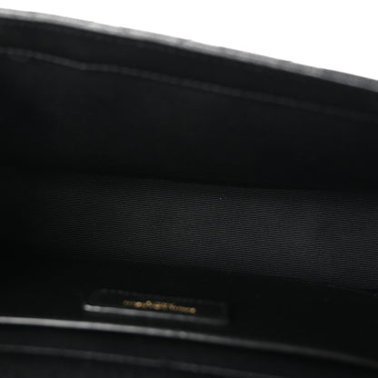 Black satchel interior lining with small gold logo tab near the top edge
