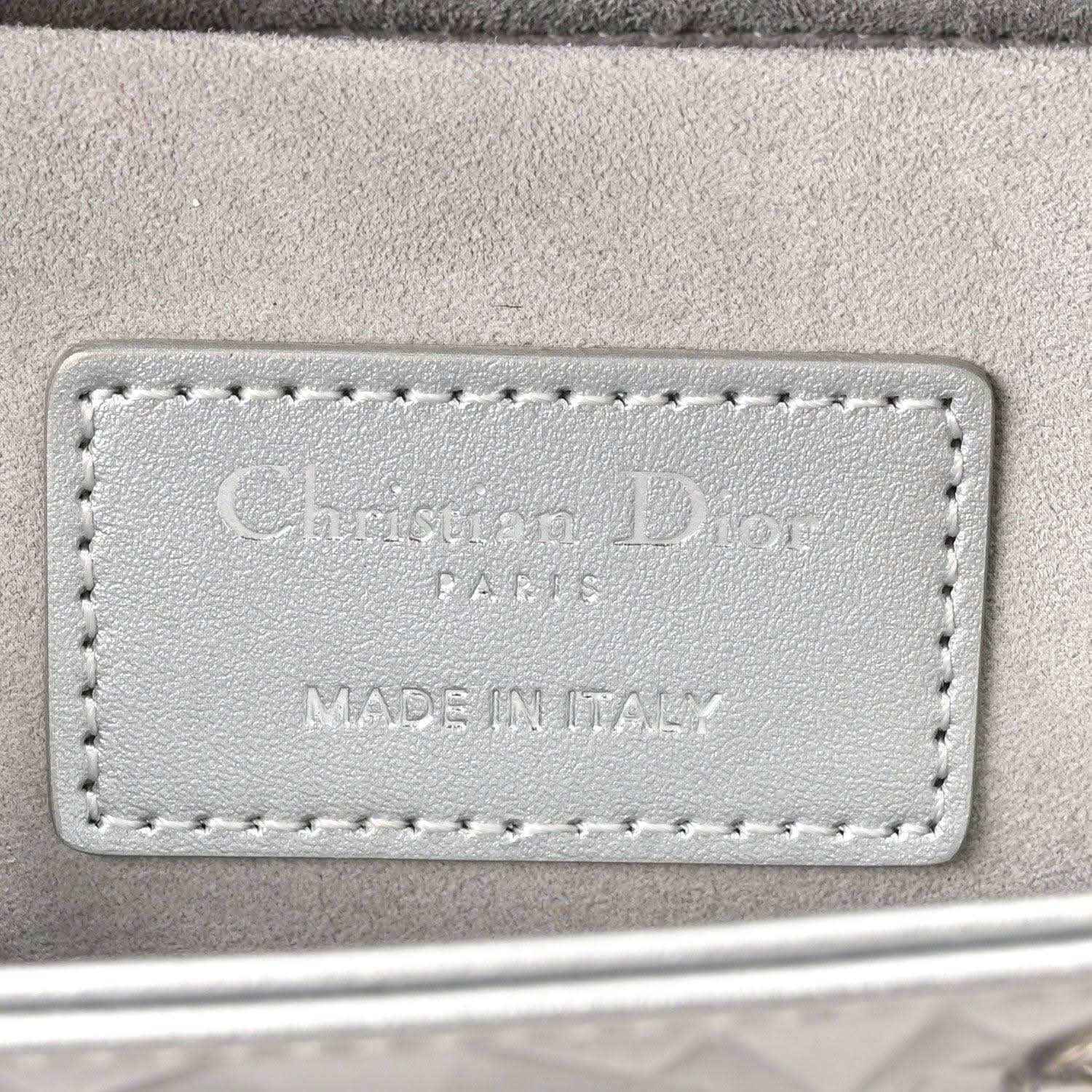 Leather handbag label with embossed text 'Christian Dior' and 'MADE IN ITALY'.