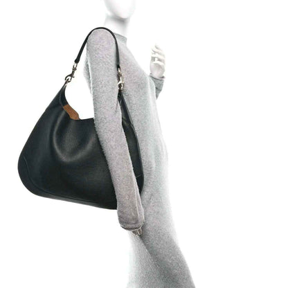 Black maxi hobo bag with green and red web strap and metal chain shoulder handles