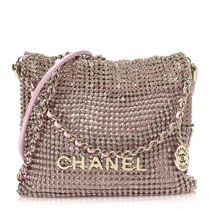 Chanel Mini 22 handbag in pink metallic crystal mesh with chain strap and logo front.