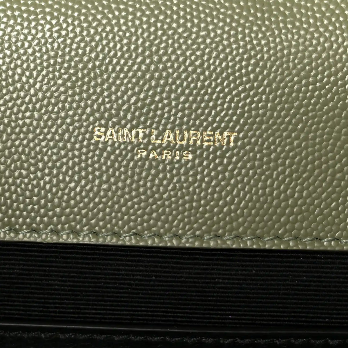 Saint Laurent Paris embossed on light sage leather panel