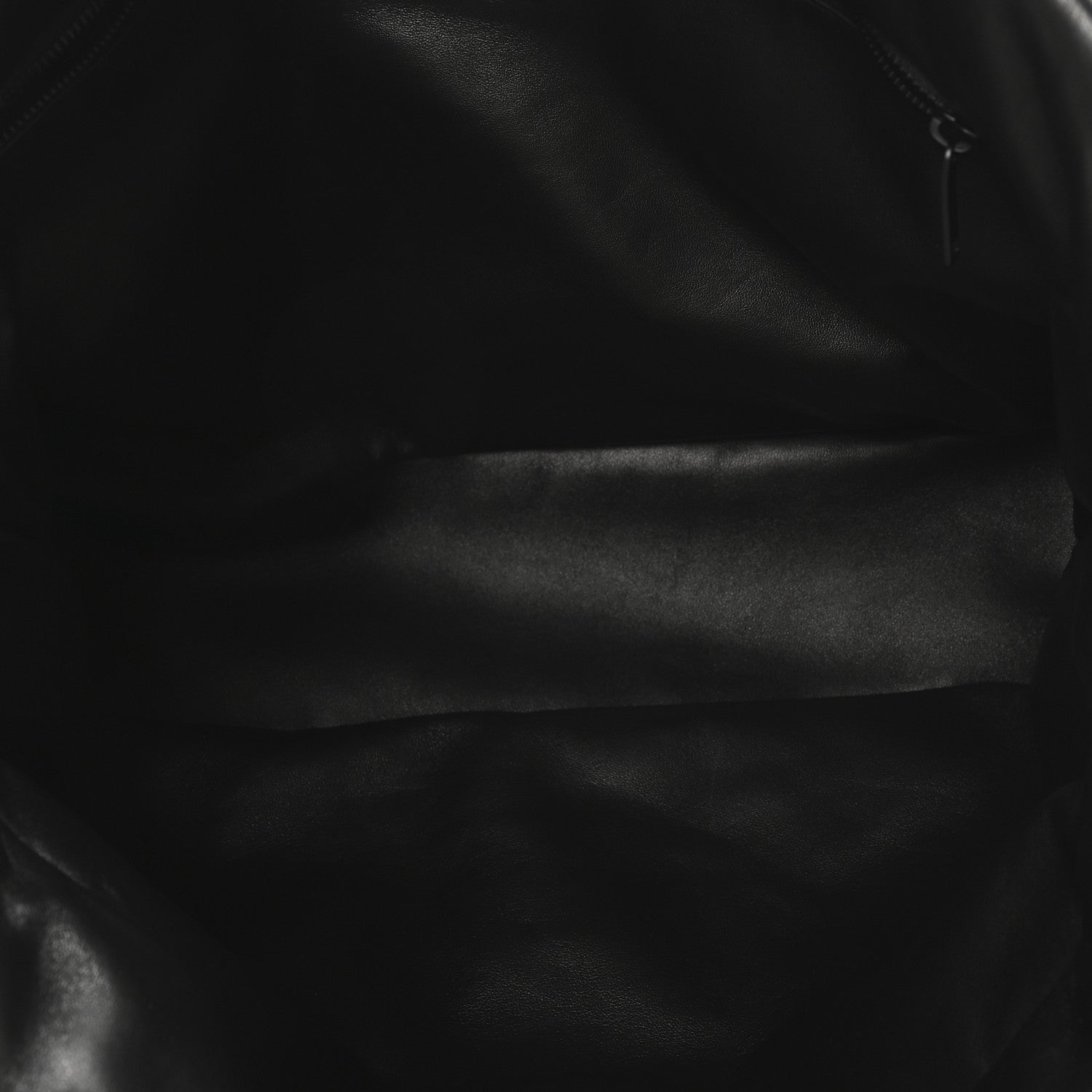 Black lambskin puffer tote close-up of smooth quilted leather surface.