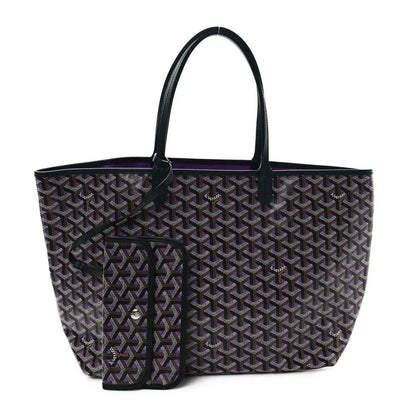 Tote bag with monogram pattern and purple trim, black exterior, front pocket with zipper