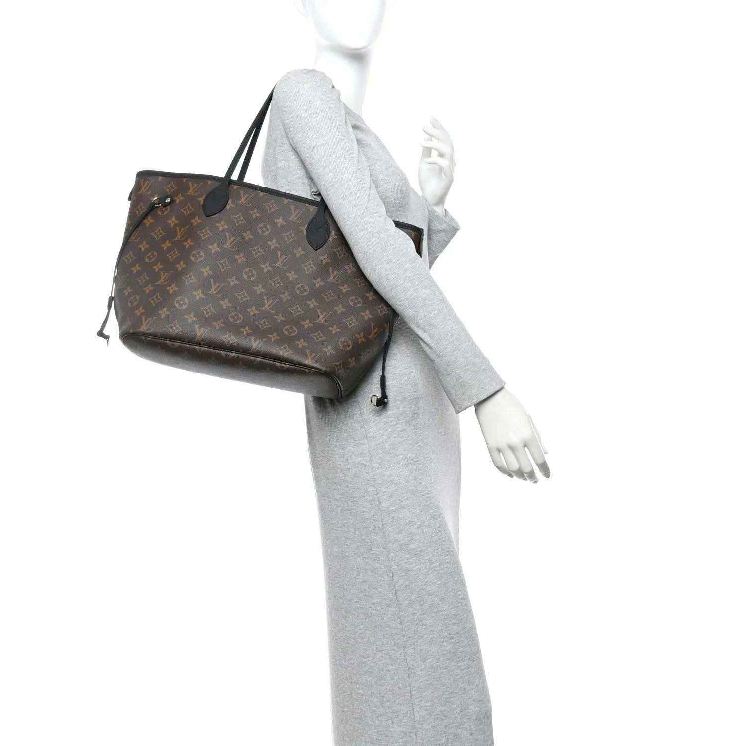 Monogram Louis Vuitton tote on a model, showing side panel and hanging strap