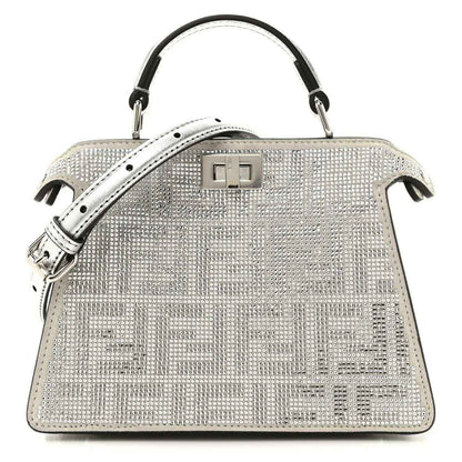 Silver crystal satchel with top handles, flap lock, and black leather trim
