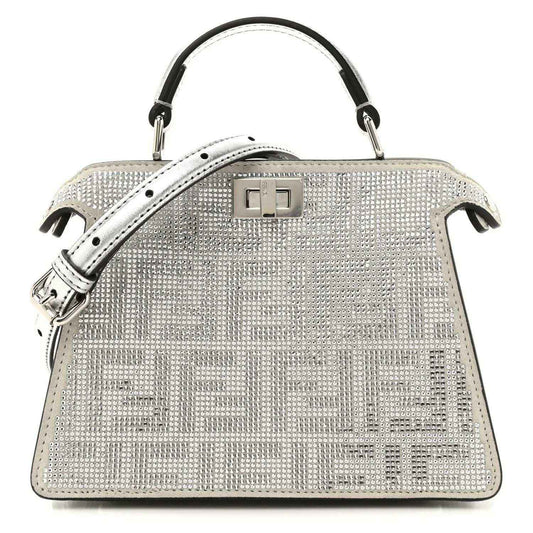 Silver crystal satchel with top handles, flap lock, and black leather trim