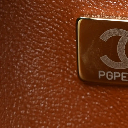 Chanel Jumbo Double Flap bag detail with metal engraving and leather texture close-up