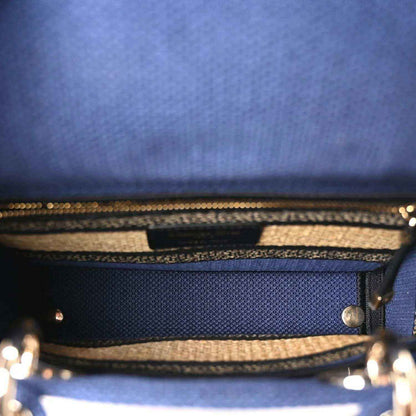 Blue handbag interior view with zipper track and woven striped trim edge