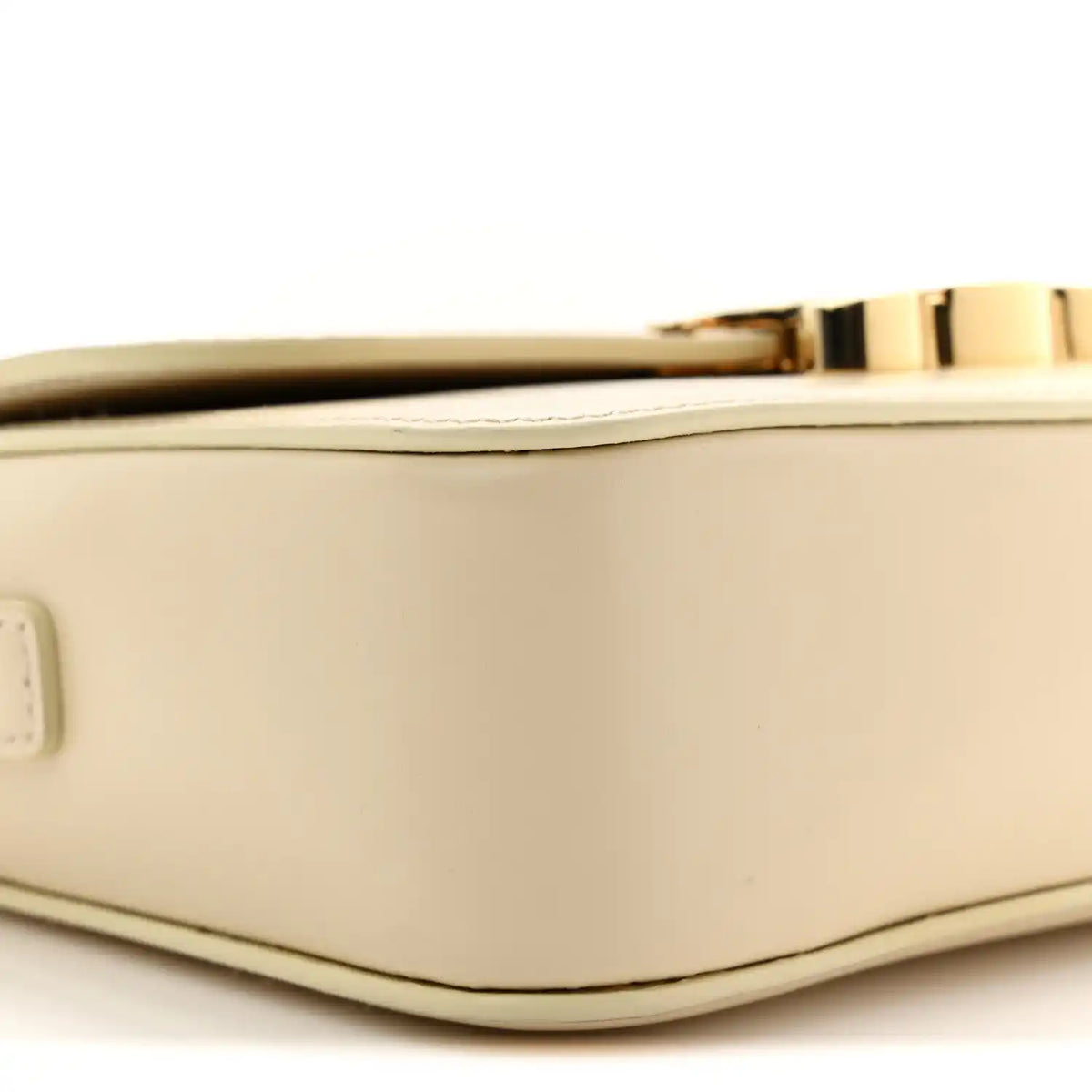 Close-up of nude calfskin edge with gold clasp bar and top trim