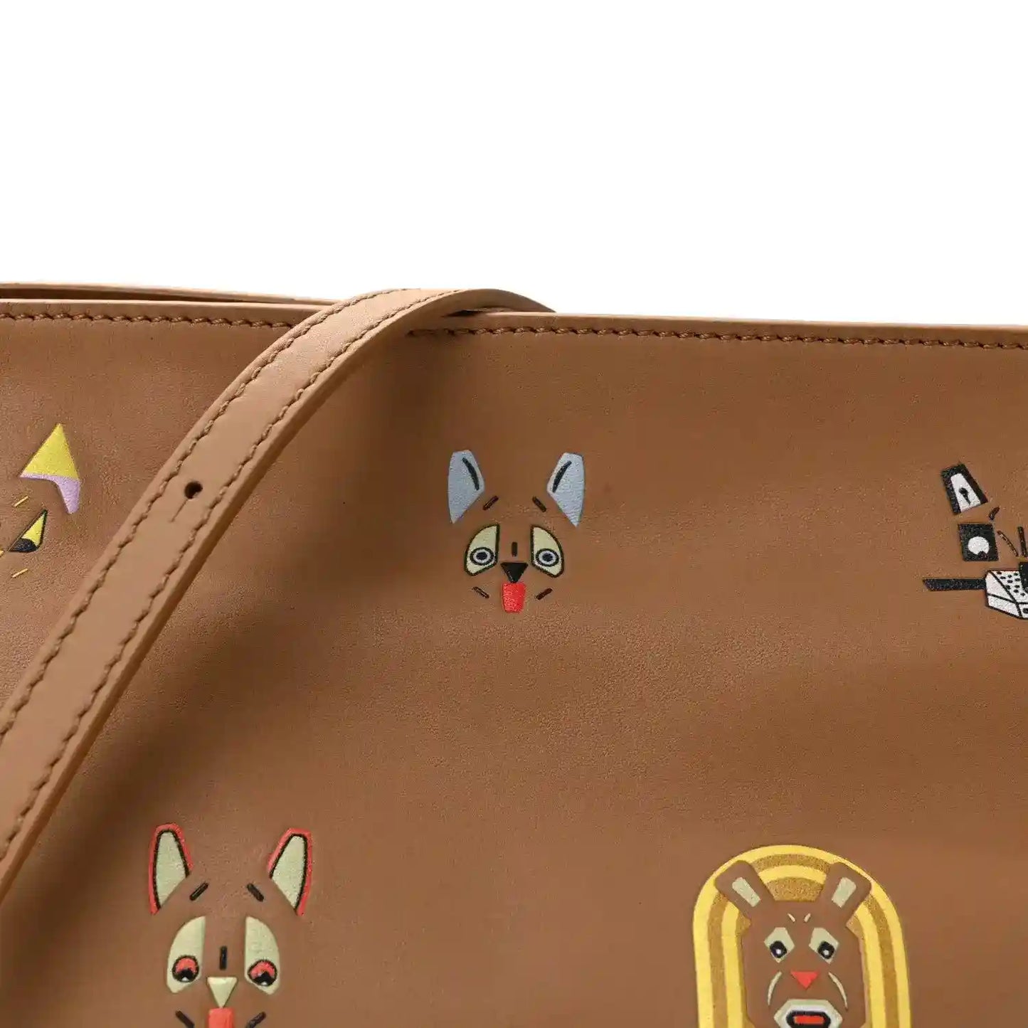 Tan mini clutch front detail with colorful animal face prints and stitched trim.