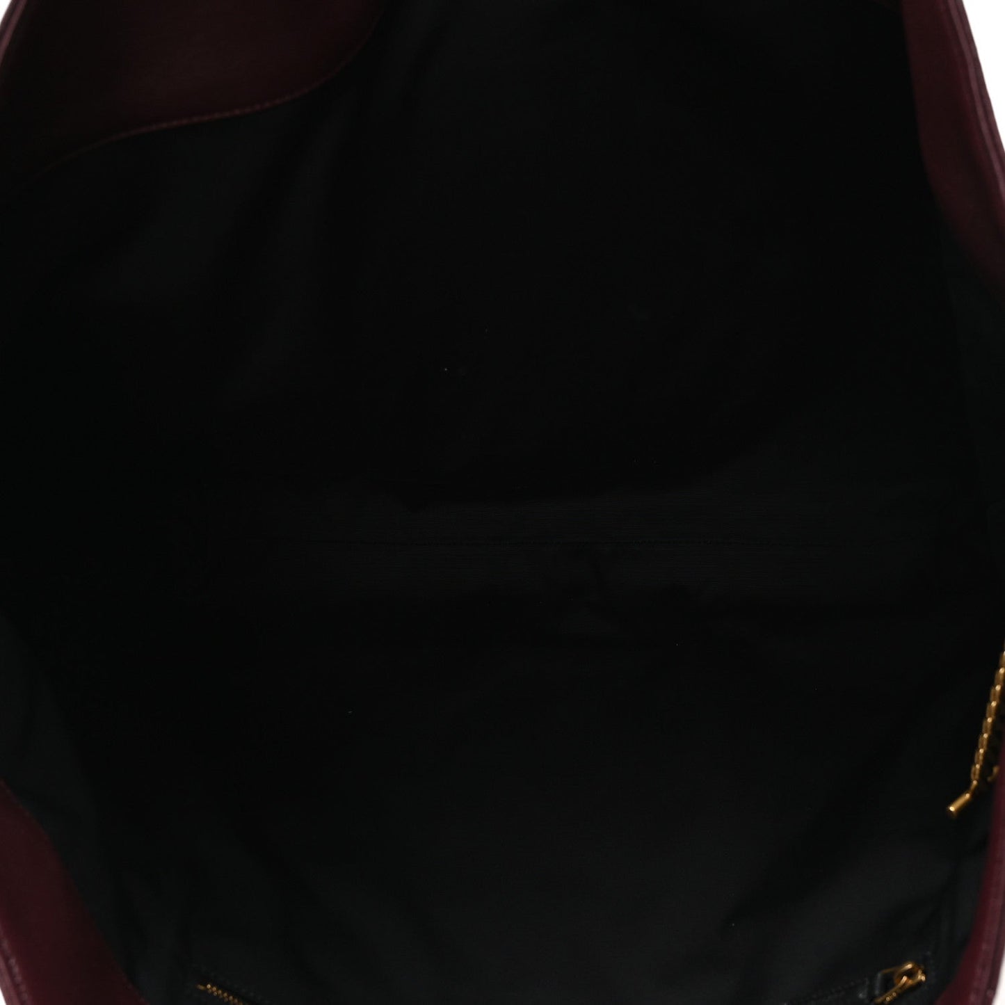 Lined interior of a quilted lambskin tote with gold-tone zipper pull