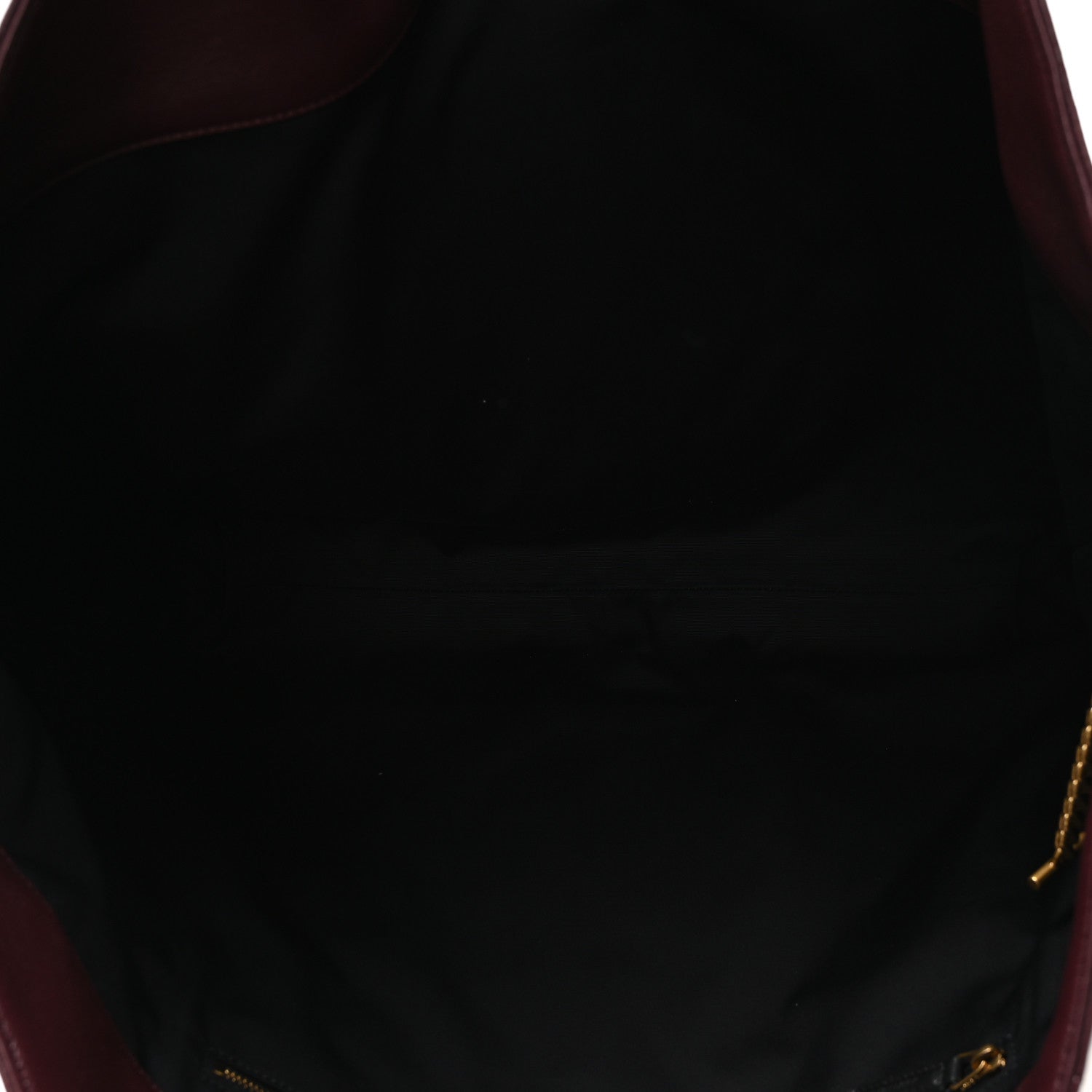 Lined interior of a quilted lambskin tote with gold-tone zipper pull