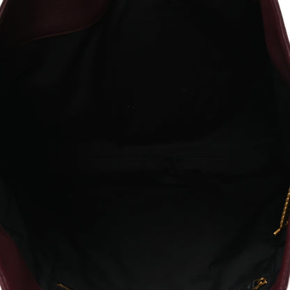 Lined interior of a quilted lambskin tote with gold-tone zipper pull