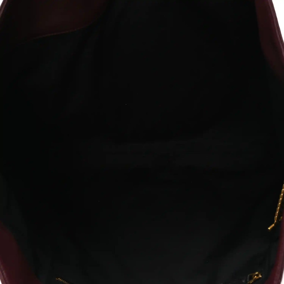 Lined interior of a quilted lambskin tote with gold-tone zipper pull