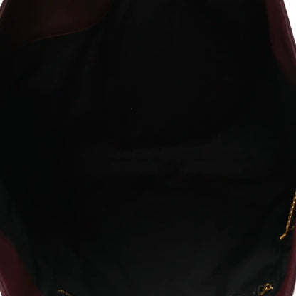 Lined interior of a quilted lambskin tote with gold-tone zipper pull