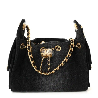 Black mini handbag with quilted caviar texture, gold chain straps, top closure