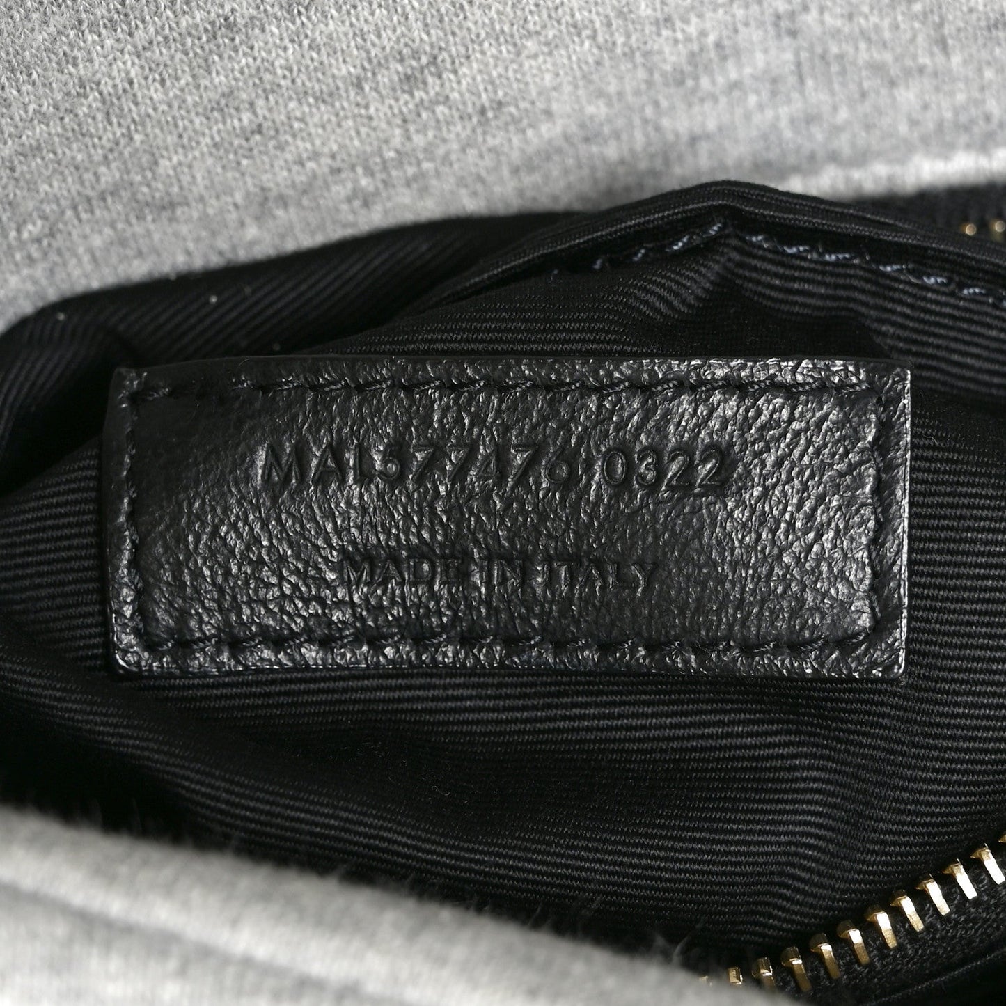 Saint Laurent interior leather date-code patch with stamped numbers.