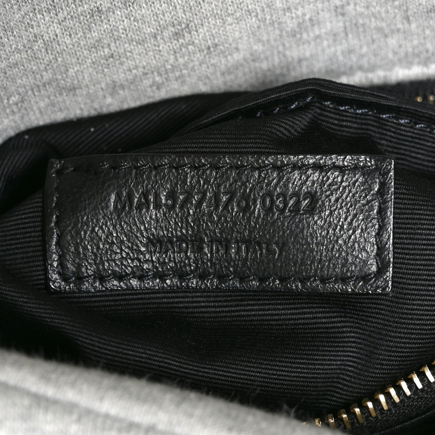 Saint Laurent interior leather date-code patch with stamped numbers.