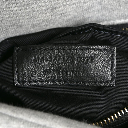 Saint Laurent interior leather date-code patch with stamped numbers.