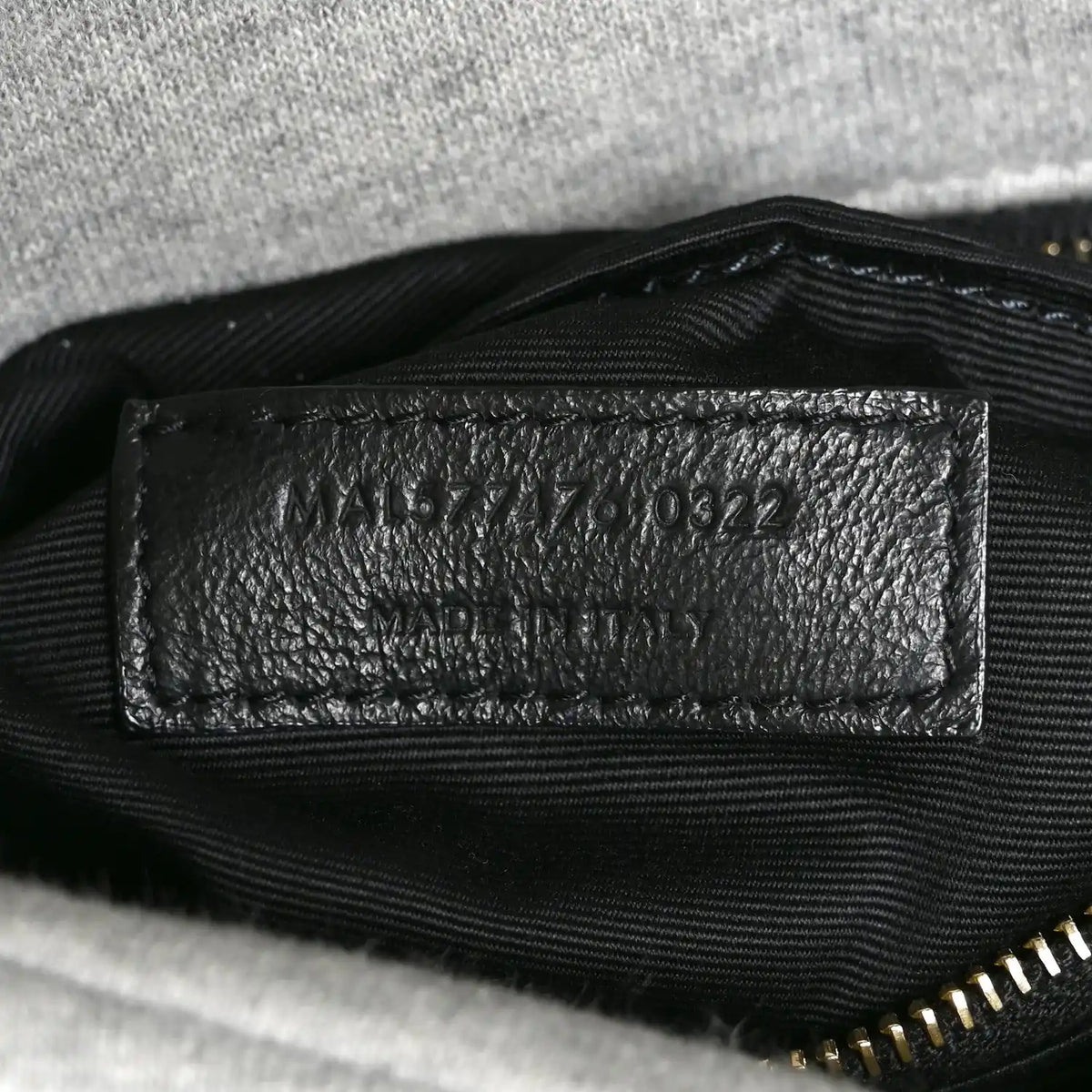 Saint Laurent interior leather date-code patch with stamped numbers.
